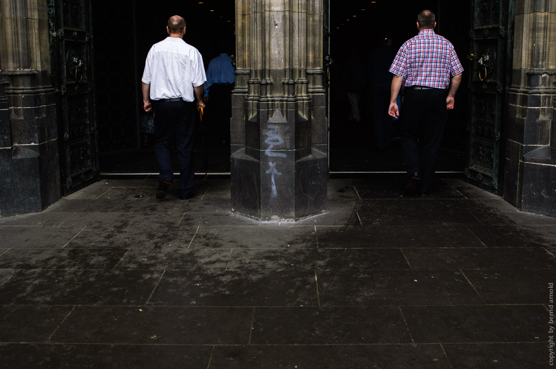 two men walked in to the Cologne cathedral at the West Portals - Photography and Portfolio